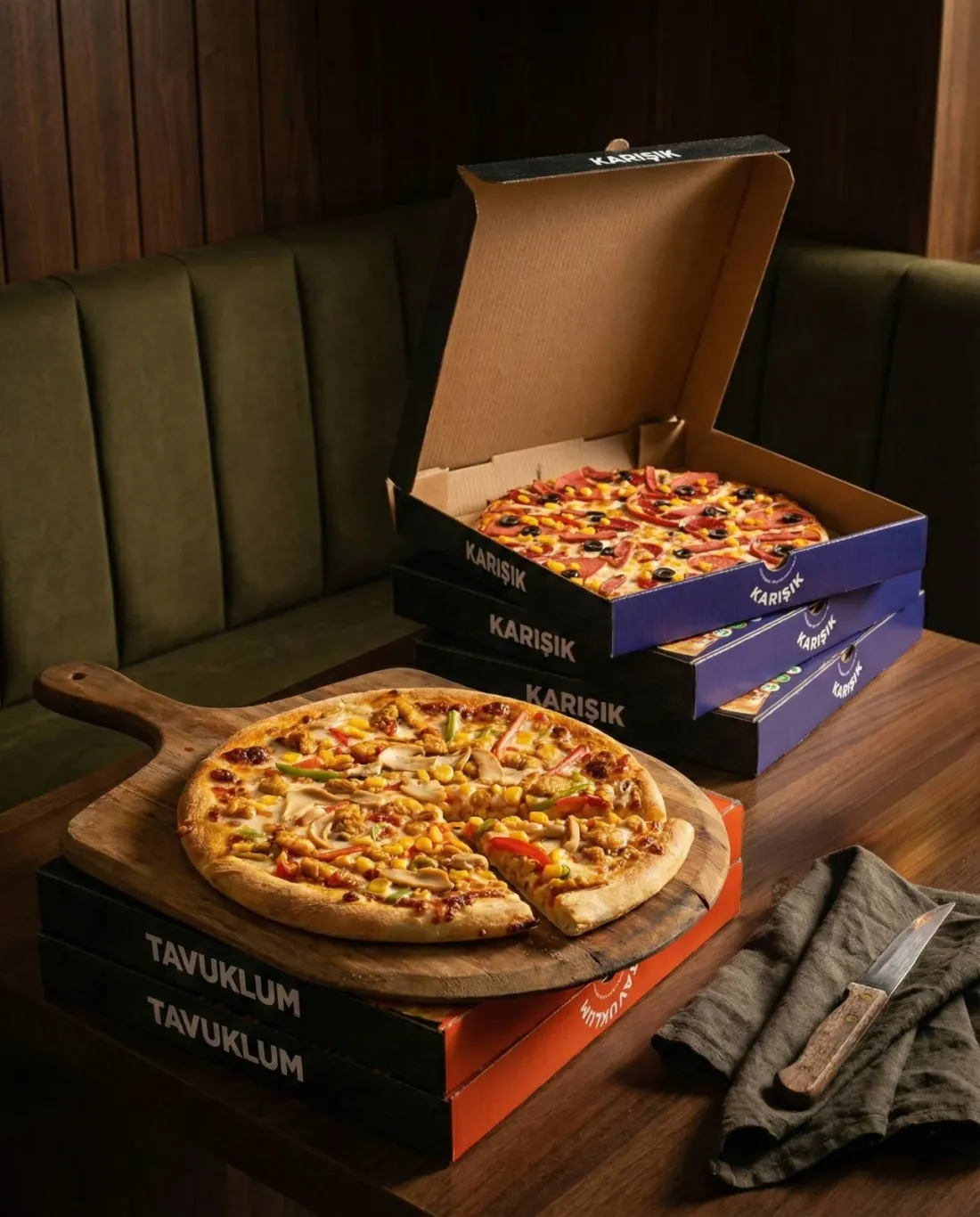 Karışık ve Tavuklum pizza kutuları, ahşap masada
